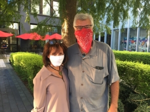man and woman wearing masks